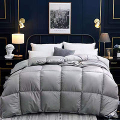 Grey winter goose down duvet on a bed in a modern, elegantly styled bedroom.