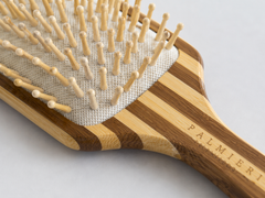 Sustainable bamboo hairbrush wooden bristles and cushion detail