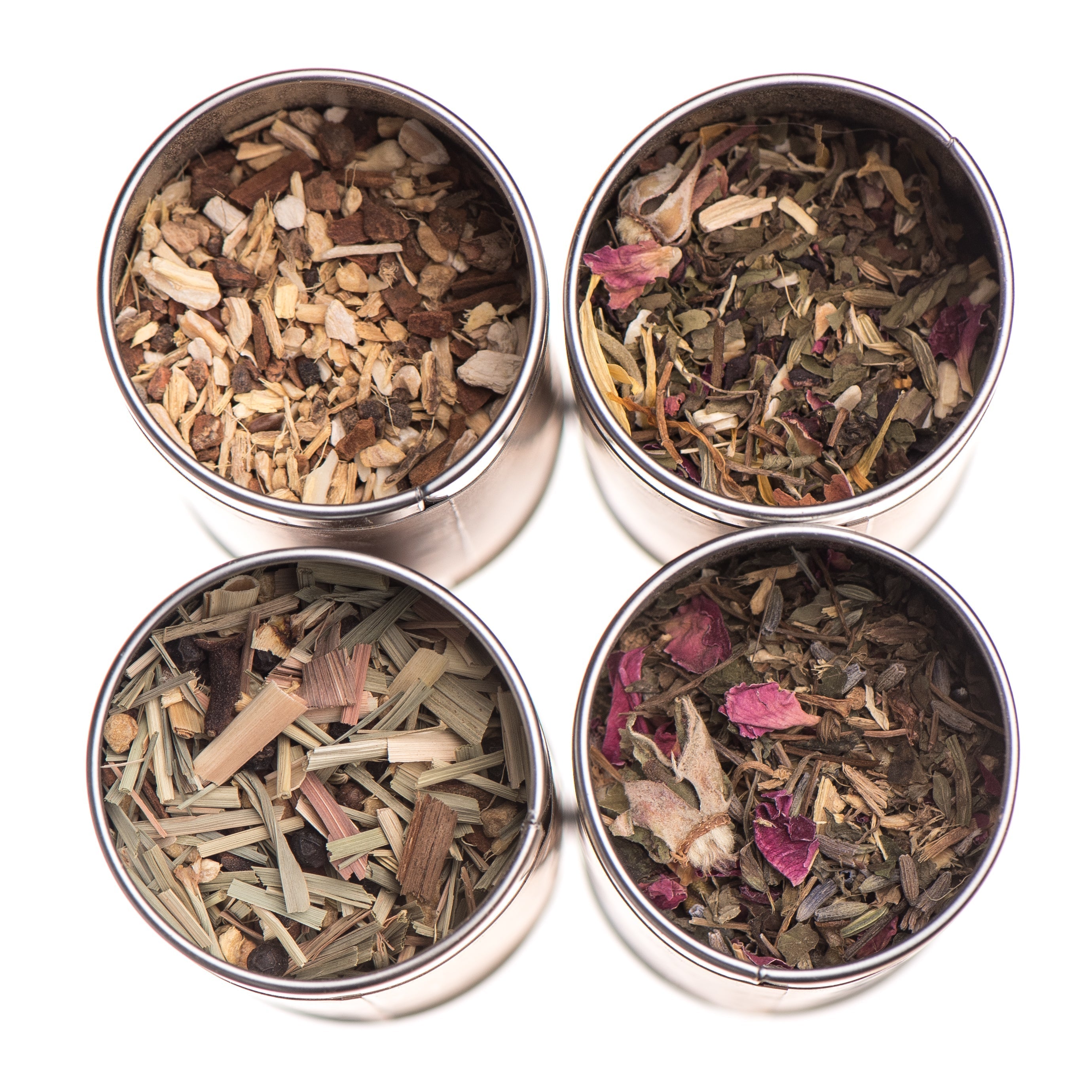 Ayurvedic herbal tea collection in stainless steel tins featuring various organic herbs and floral blends.