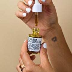 Botanical Face Serum dropper pipette dispensing golden facial oil