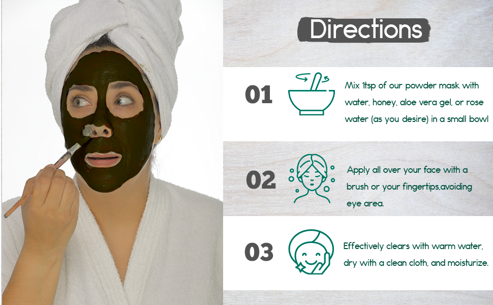 A woman applying an activated charcoal face mask, following directions for a rejuvenating facial treatment.