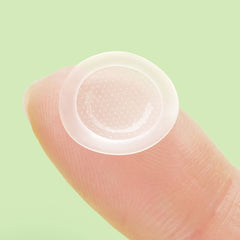triple acid spot care patch on a fingertip showcasing its slim design and microdart texture