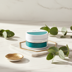 24k golden eye patches placed elegantly on a marble surface with greenery.