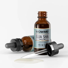 Close-up of WOW MD LLC Gua Sha Face Oil bottle with dropper, showing the facial care product on a neutral background.