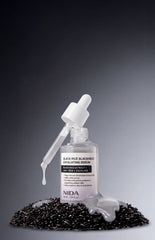 NIDA Black Rice Blackhead Exfoliating Serum with dropper on black rice grains, promoting blackhead exfoliating serum benefits.