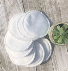 Set of reusable facial round pads included in the eco-friendly facial skincare bundle, displayed with a succulent plant.