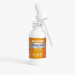 Bottle of WOW MD LLC Vitamin Glow Serum for facial care with brightening and hydrating effects, displayed on a clean surface.