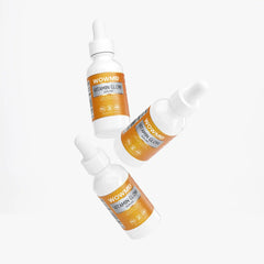 Bottle of WOW MD LLC Vitamin Glow Serum for facial care, featuring clear glass container and dropper applicator.