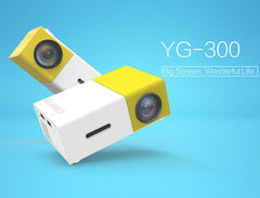Yellow and white YG-300 1080p mini projector against a blue background.