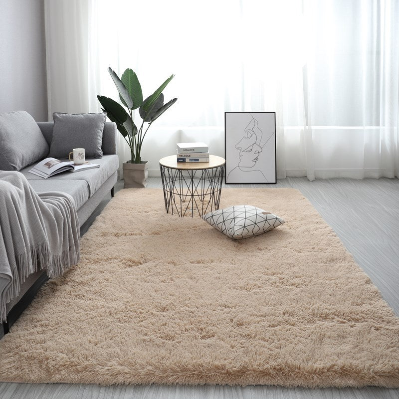 Plush beige nordic fluffy bedroom rug in a modern living room with a grey sofa and wire coffee table.