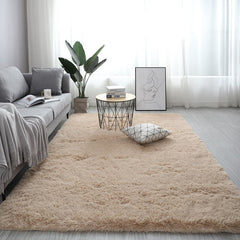 Plush beige nordic fluffy bedroom rug in a modern living room with a grey sofa and wire coffee table.