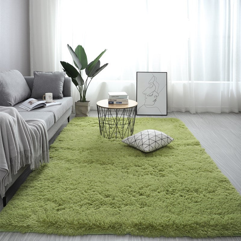 Soft green nordic fluffy bedroom rug in a modern living room layout with a grey sofa and potted plant.