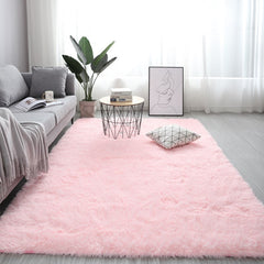 Plush light pink nordic fluffy bedroom rug styled in a modern minimalist living room next to a grey couch.