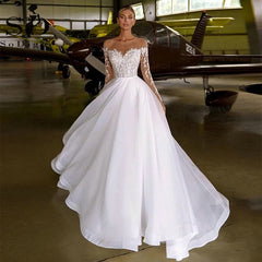 Robe de mariée brodée à manches longues et épaules dénudées