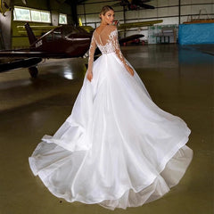 Robe de mariée brodée à manches longues et épaules dénudées