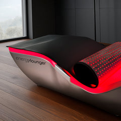 EnergyLounger infrared light therapy blanket on hardwood floor.