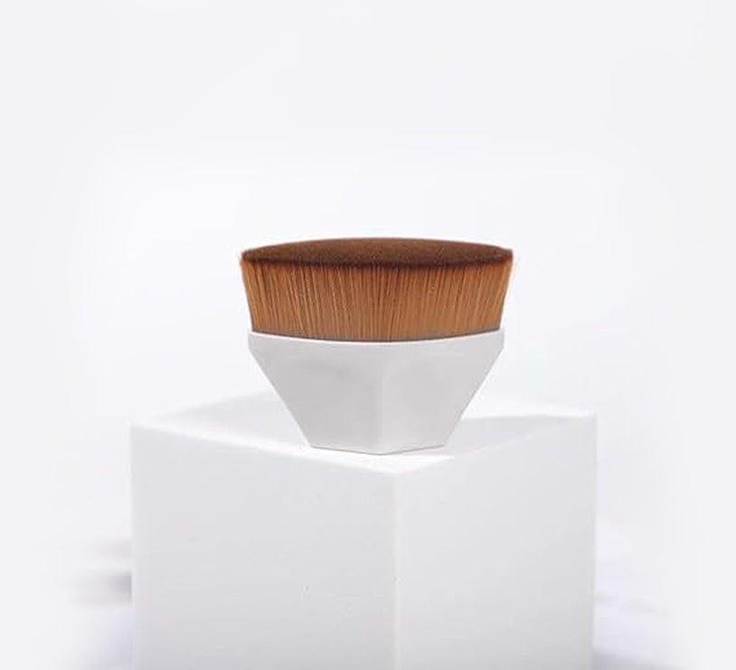 Foundation makeup brush for smooth application on a clean pedestal with soft bristles and a solid handle.