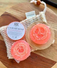 natural loofah soap bar with peach and vanilla on bamboo dish