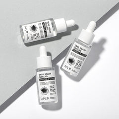 snail mucin ginseng serum bottles placed on a gray background