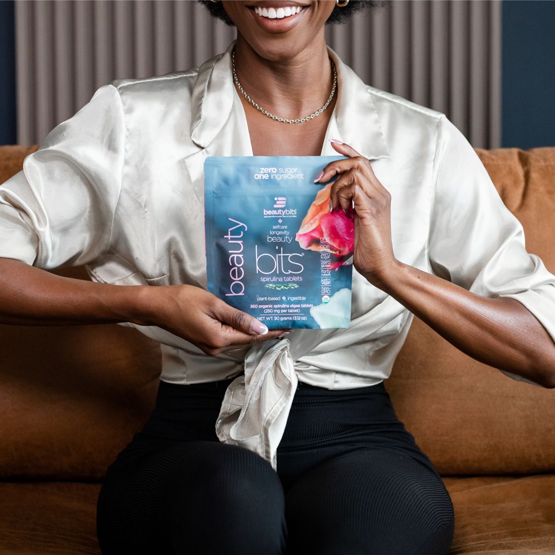 Woman taking BEAUTYbits Spirulina Tablets for glowing skin and wellness