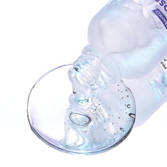 pore reducing serum pouring onto a glass surface, showcasing its lightweight texture.