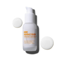 FRANKLY Sunday Glow serum for dull skin with a pump top and two drops of product beside the bottle.
