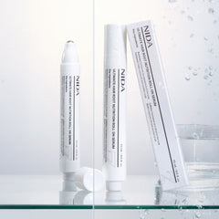 NIDA Ultimate Hair Root Nutrition Roll On Serum 15ml bottles on display with water droplets.