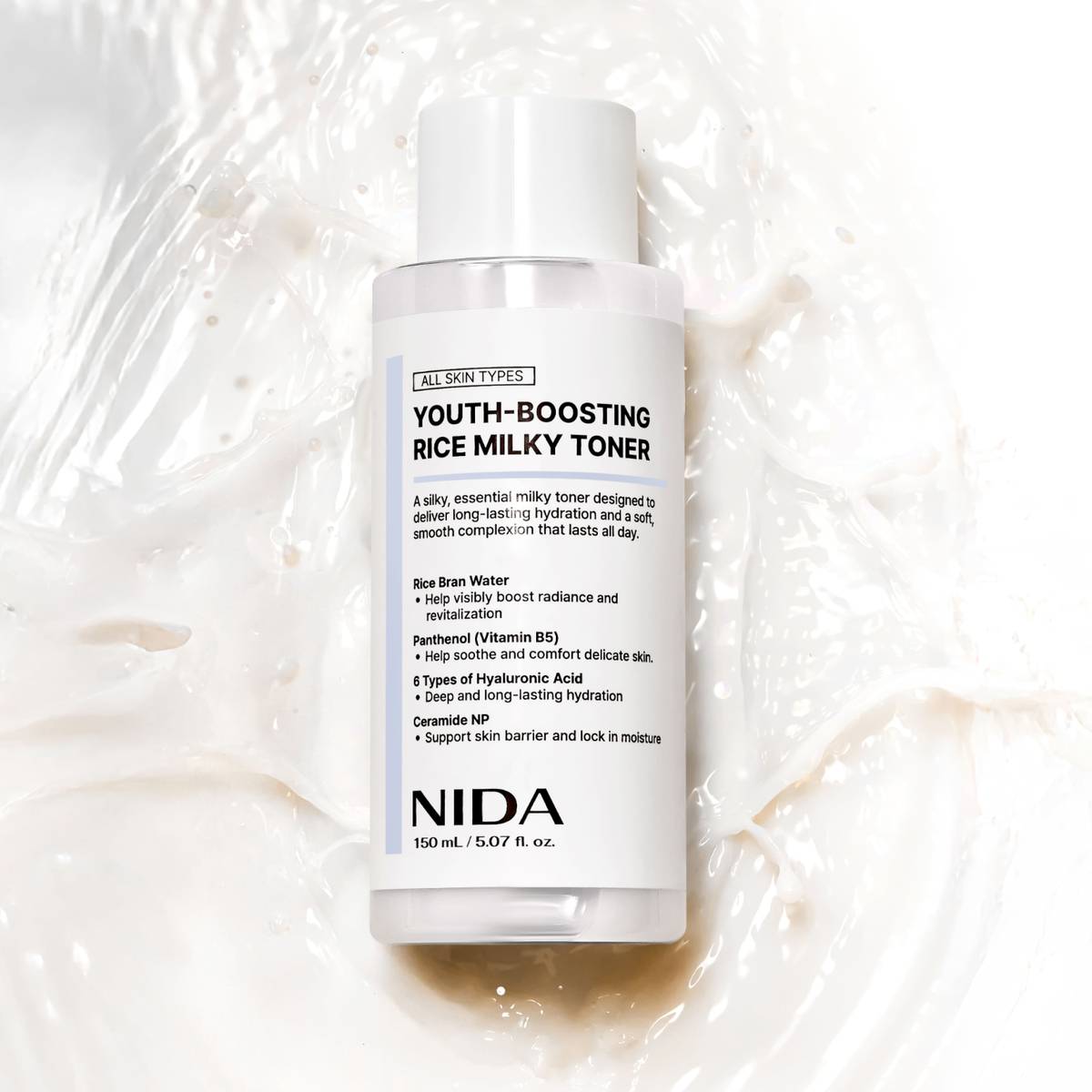 NIDA Youth-Boosting Rice Milky Toner 150ml bottle on a creamy background, promoting hydration and brightness.
