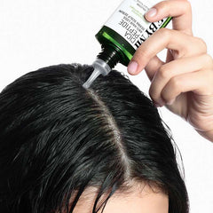 anti hair loss scalp serum being applied to damp hair for nourishment.